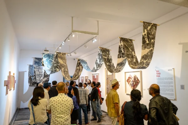 Público recorriendo la exposición Testimonial en sala de CuatroSie7e Galería Vista de sala de la exposición Testimonial con público y obra instalada en CuatroSie7e Galería